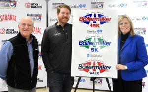 The Boilermaker Road Race unveiled the 2023 race logos at a press conference this morning. The logos were designed by McGrogan Design for the fifth consecutive year. From left: Mark Donovan, president of the Boilermaker Road Race, Ryan McGrogan, owner of McGrogan Design and Eve Van de Wal, regional president at Excellus BCBS, presenting sponsor of the Boilermaker 15K Road Race.