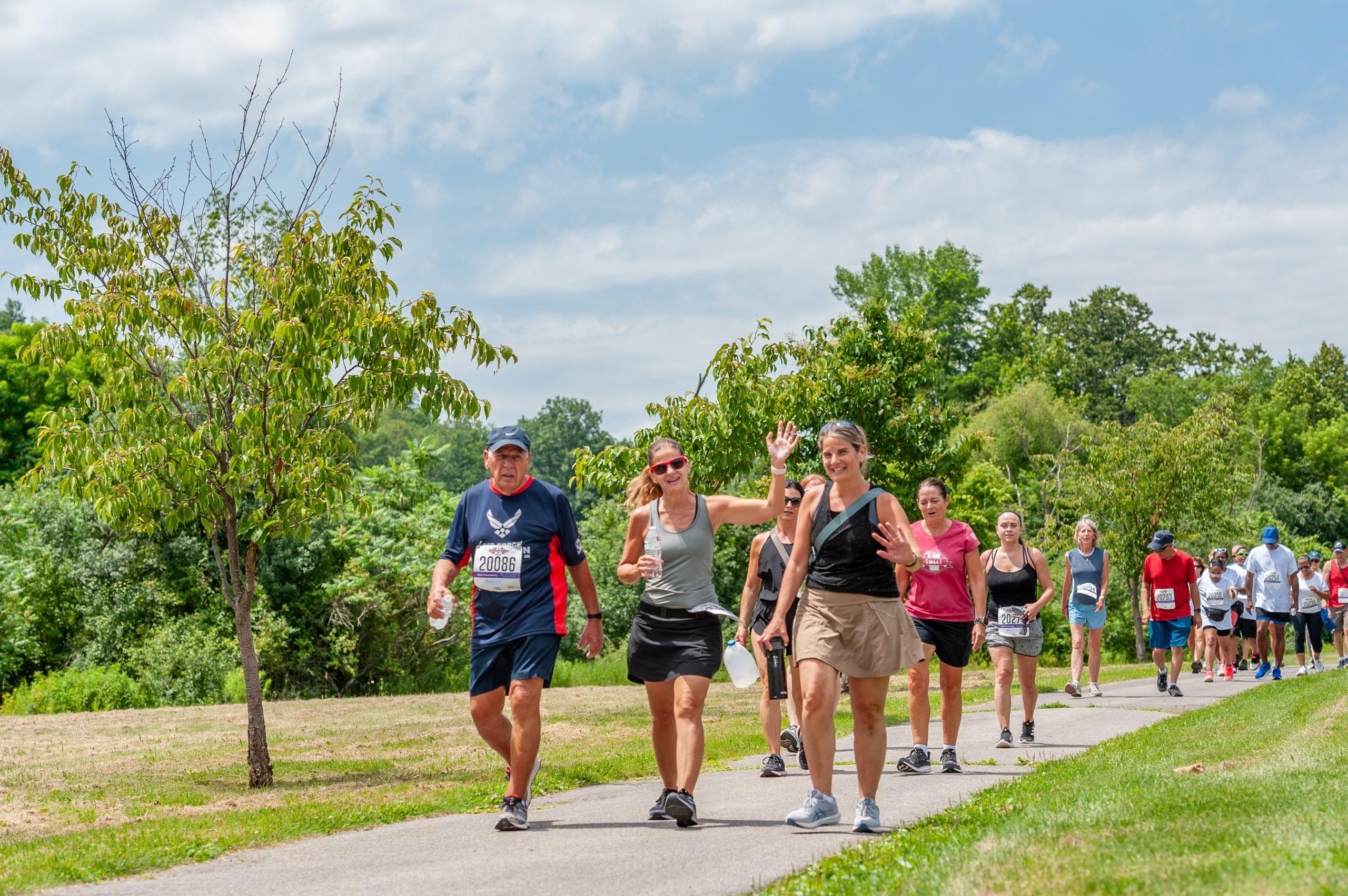 Walkers wave to the camera during the 2023 Boilermaker Walk.