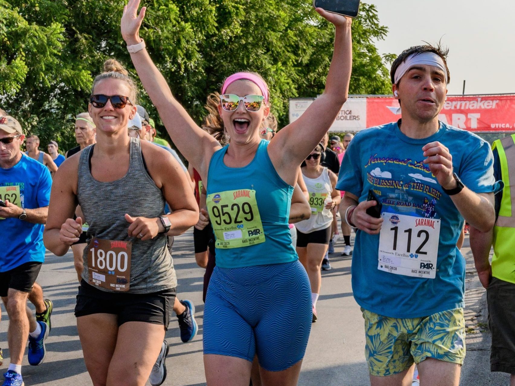 A group of runners smile for the camera at the Boilermaker 15K start line