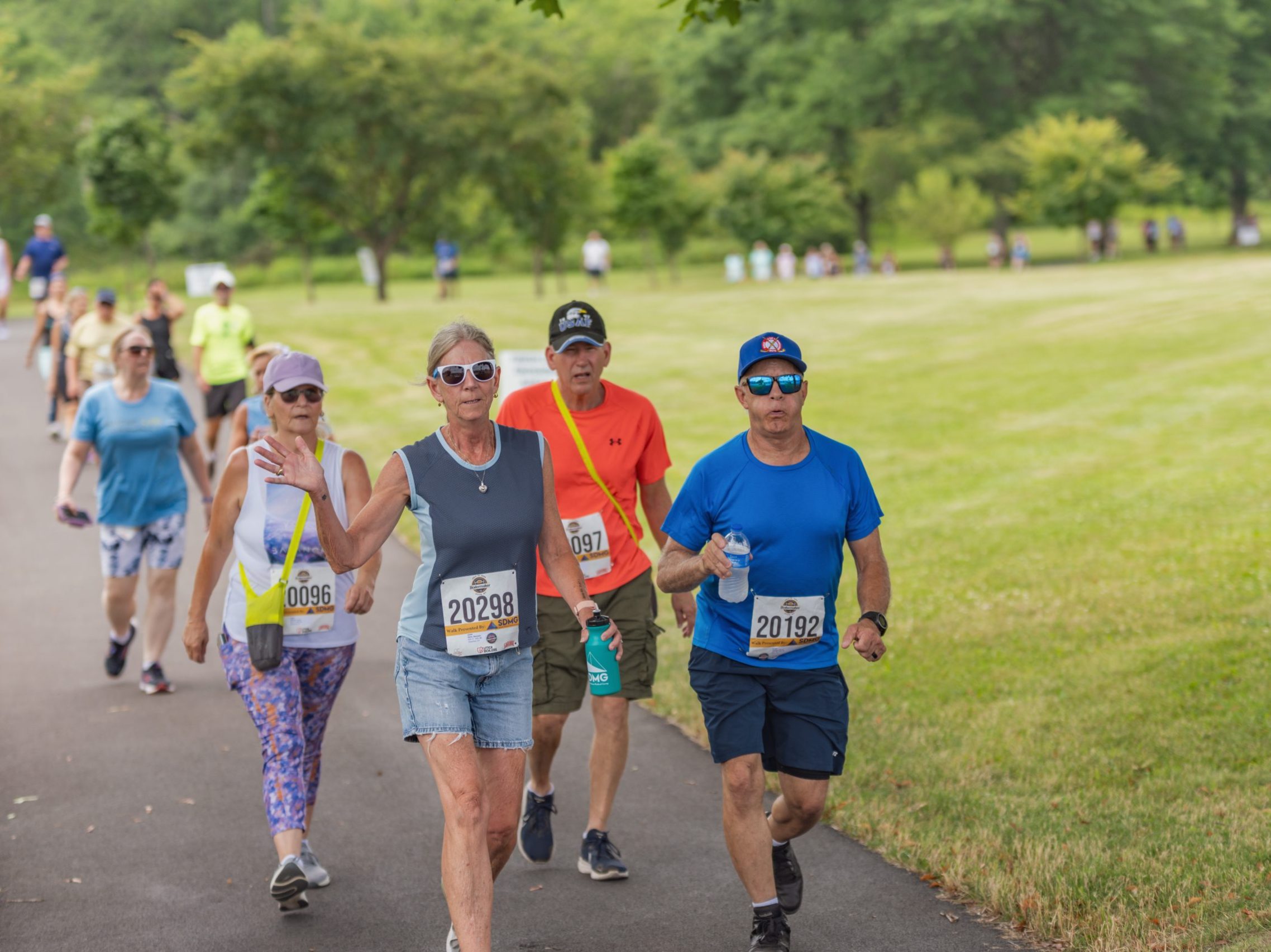 Walkers wave to the camera during the Boilermaker walk