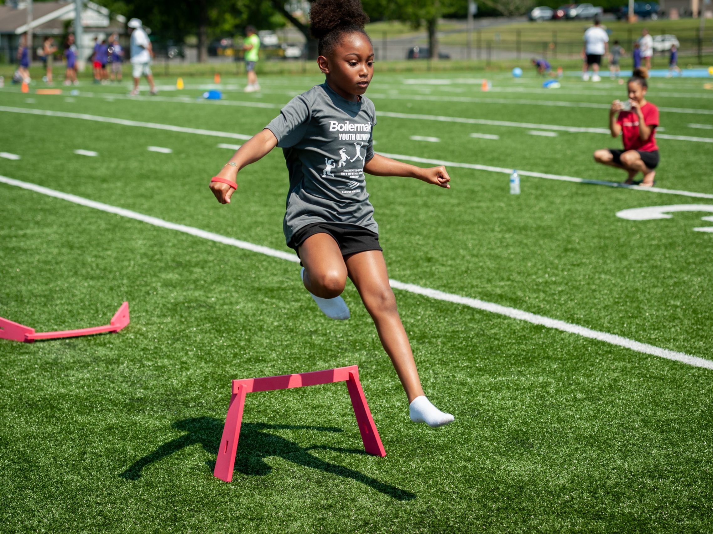 Participant leaps over a hurdle during the 2023 Boilermaker Youth Olympics