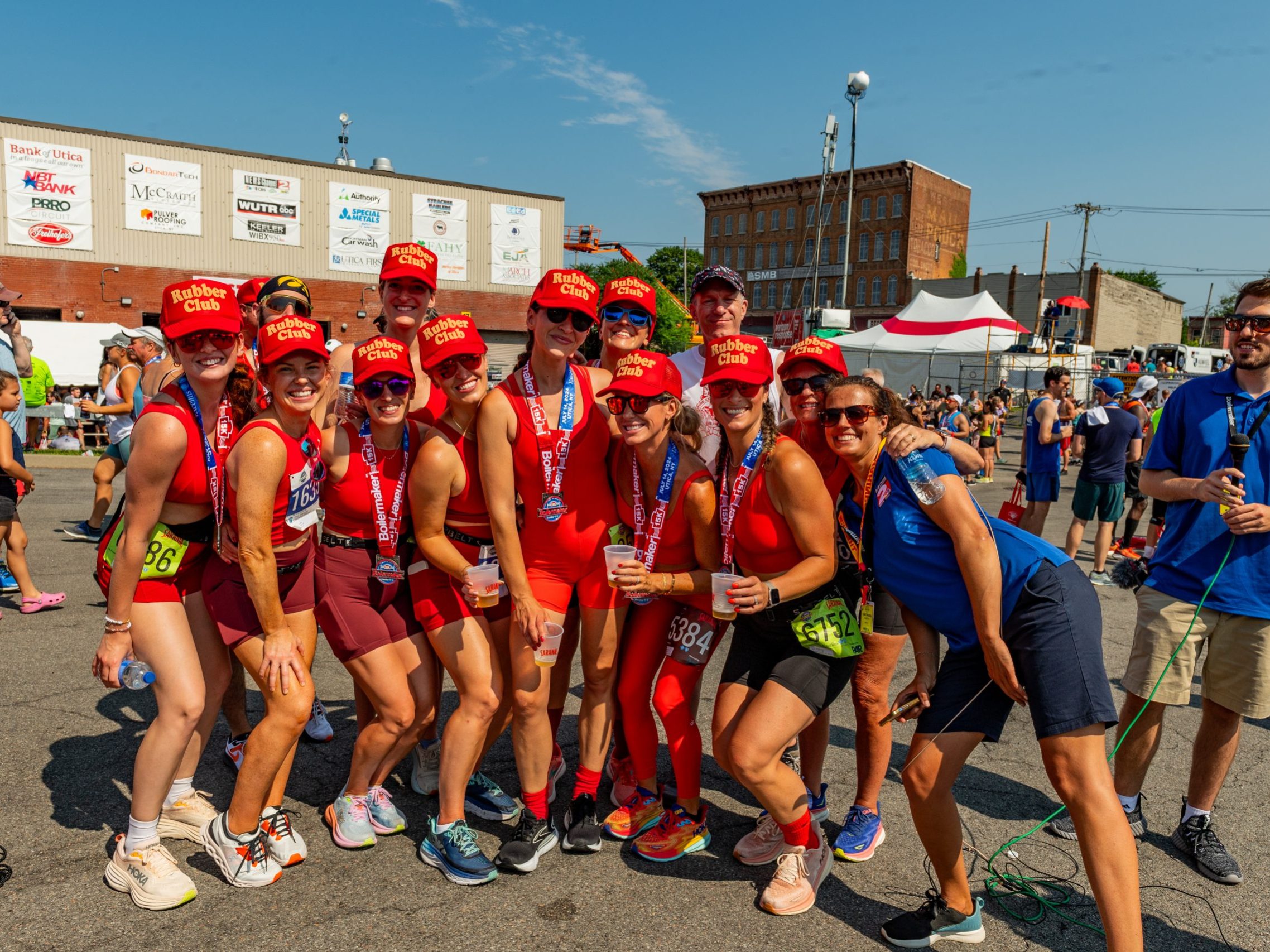 Members of the rubber club pose with WKTV reporters at the post-race party