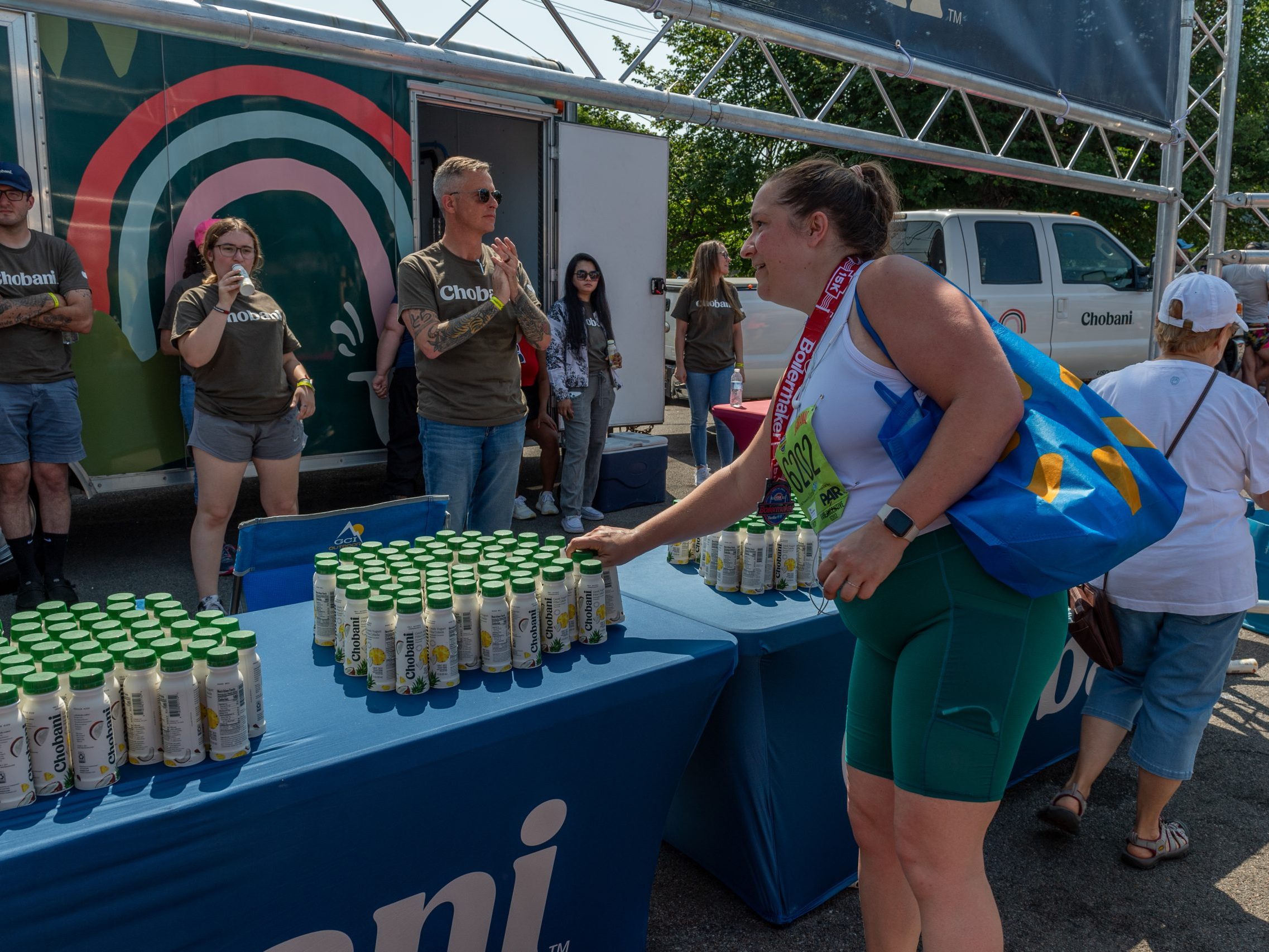 A runner grabs a Chobani drinkable yogurt at the Post-Race Party