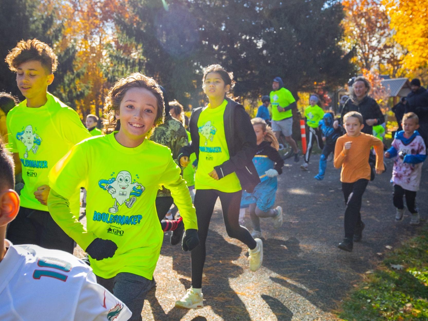 A group of runners smile at the camera at the Boolermaker