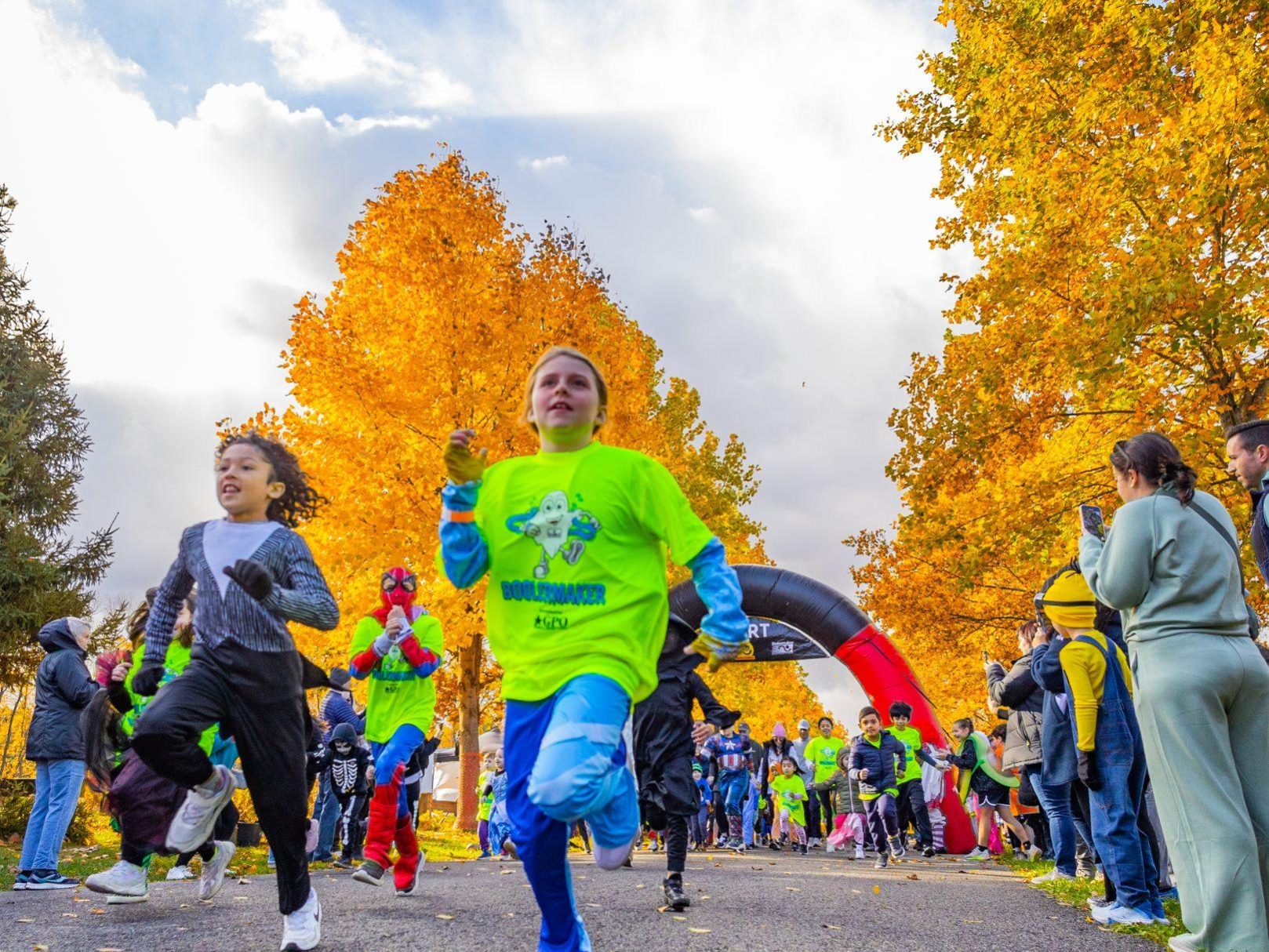 Runners take off past the start line
